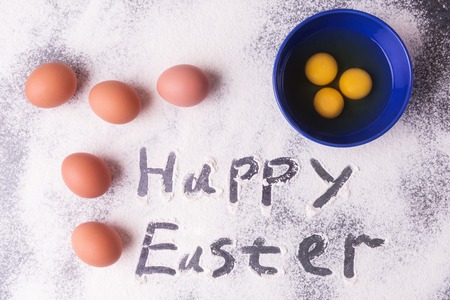 Easter baking, eggs and flour on stoneの写真素材
