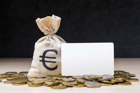 Money bag with Euro coins and blank bank card with copy spaceの写真素材