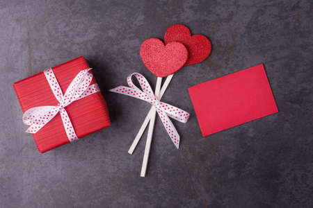 Gift box, red hearts and blank card on dark stone background. Valentineâs day conceptの写真素材