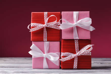 Pink and red gift boxes pile over pink backgroundの写真素材