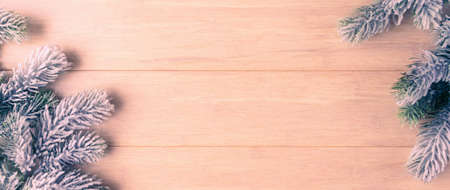 Frosty Christmas tree branches on wooden background with copy spaceの写真素材
