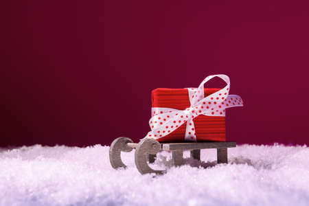 Santa's sleigh with red gift box in snow. Christmas and New Year conceptの写真素材