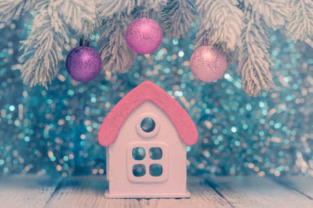 Toy house with pink roof and Christmas decoration. New Year and Christmas conceptの写真素材