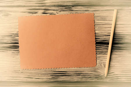Blank card with pencil on vintage wooden backgroundの写真素材