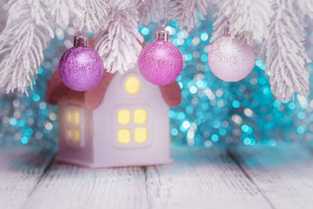 Christmas balls over defocused toy house. New Year and Xmas conceptの写真素材