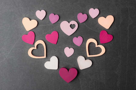 Multicolored decorative hearts on grey stone background. Valentine âs Day conceptの写真素材