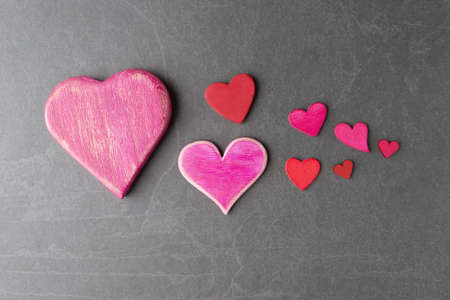 Various Valentineâs hearts on grey stone backgroundの写真素材