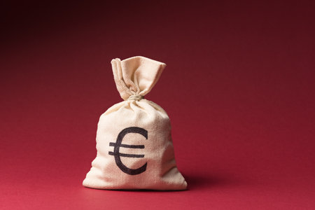 Money bag with Euro symbol over red background with copy spaceの写真素材