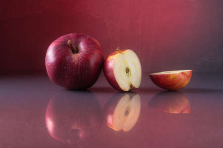 Red apples over background with red backlightの写真素材
