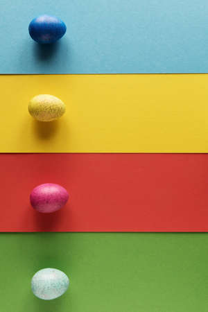 Decorative Easter eggs on colored cardboardsの写真素材
