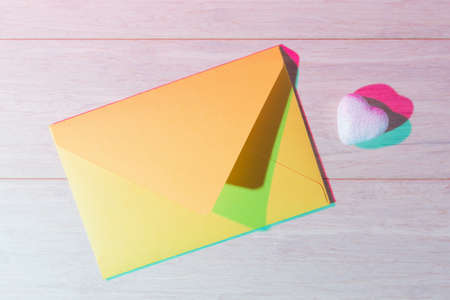 Yellow envelope and decorative heart with double colorful shadows