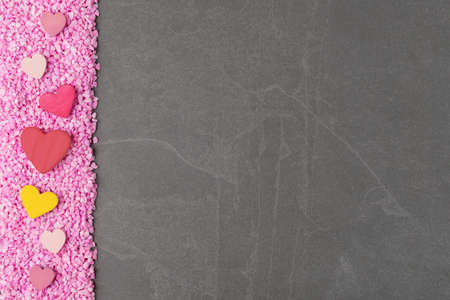Valentineâs day background with decorative hearts on pink rocks and grey stone copy spaceの写真素材
