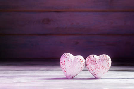 Two decorative valentines hearts over defocused wooden background with copy space. Valentineâs day cardの写真素材