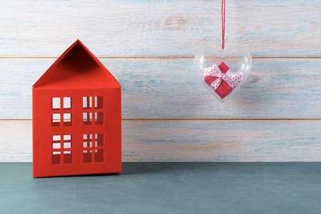 Red house and gift box in heart-shaped container. Valentines day conceptの写真素材