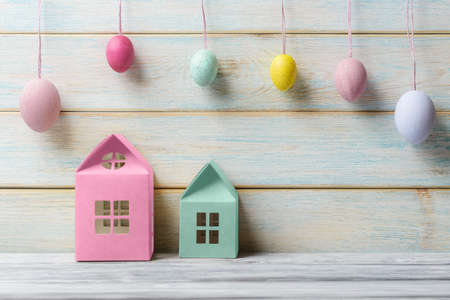 Easter greeting card with colored houses models and decorated eggsの写真素材