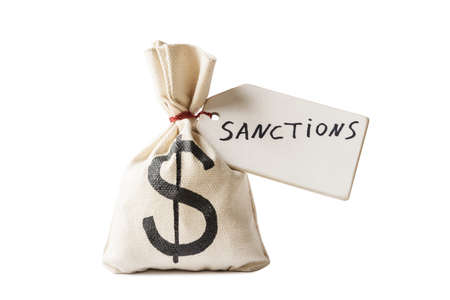 Money bag with US dollar symbol and tag with word sanctions. Isolated on white backgroundの写真素材