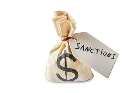 Money bag and label with word sanctions isolated on white background. Contemporary political and economic problems conceptの写真素材