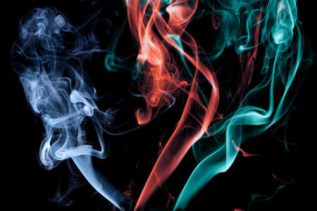 Abstract background with multicoloured smoke jets on blackの写真素材