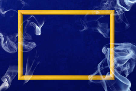 Yellow frame with smoke over dark blue backgroundの写真素材