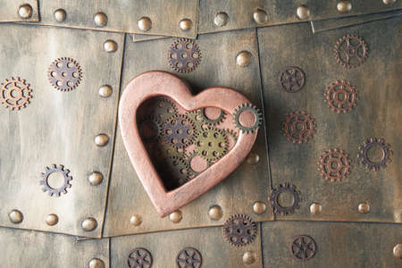 Steampunk concept with heart and gears on metal background. Valentines day greeting conceptual greetingの写真素材
