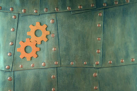 Top view of gears on metal background with rivets. Steampunk style backdrop with copy spaceの写真素材