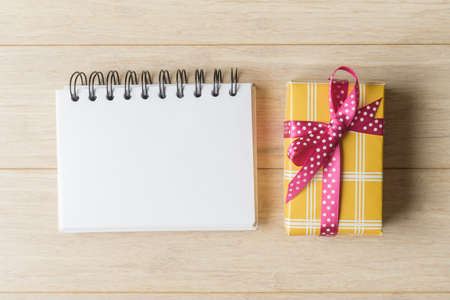 Gift box and blank notebook with copy spaceの写真素材