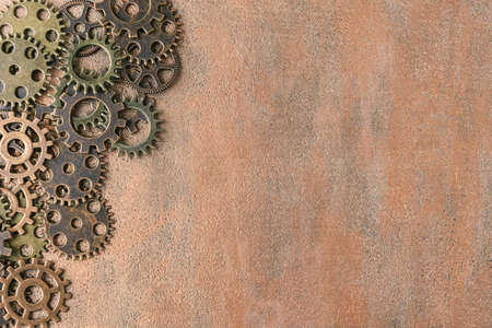 Gears on copper metallic background with copy space. Steampunk backgroundの写真素材