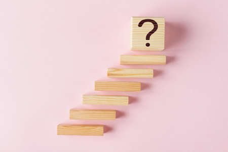 Wooden blokes as stairs and cube with question mark. Concept of Effective Goal Settingの写真素材