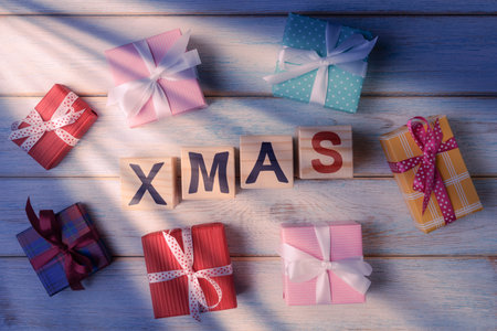 Gift boxes and wooden cubes with digits 2023. Christmas and New Year background