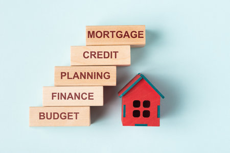 House model and wooden blocks with words Budget, Credit, Planning, Finance, Mortgage. House purchasing and mortgage conceptの写真素材