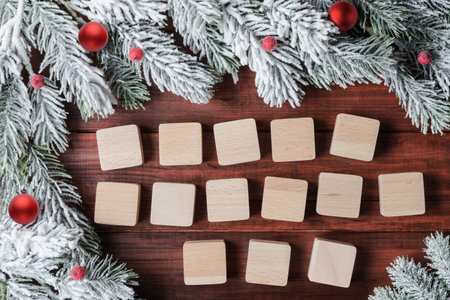 Christmas background with frosty fir branches and 14 blank wooden blocks. Template for Christmas card design. Decoration templateの写真素材