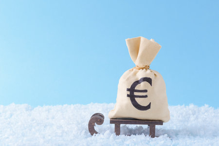 Money bag with Euro symbol on Santaâs sleigh over blue background with copy spaceの写真素材