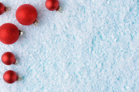 Red Christmas balls on snowy background with copy space. Xmas and New Year cardの写真素材