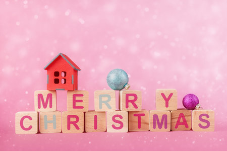 Wooden cubes with caption Merry Christmas and Xmas decoration over abstract holiday backgroundの写真素材