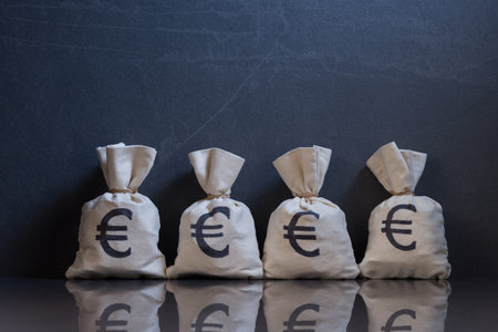 Money bags with USD symbols on light wooden background with copy spaceの写真素材