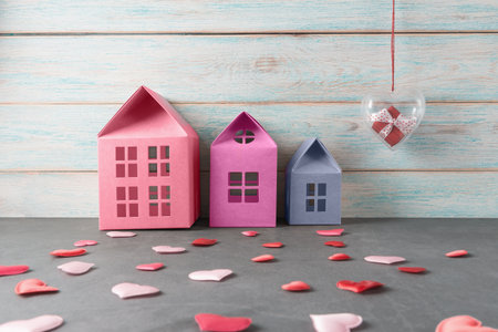 Toy housed and valentines hearts over wooden background. Valentineâs day greeting cardの写真素材