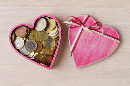 Heart shaped gift box with Uuro coins inside. Business Ideas for Valentineâs Day conceptの写真素材