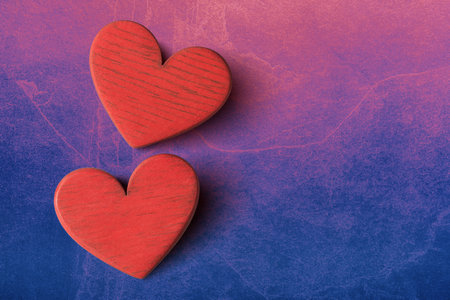 Close up of two valentines hearts on pink blue stone background with copy space. Valentines day greeting card templateの写真素材
