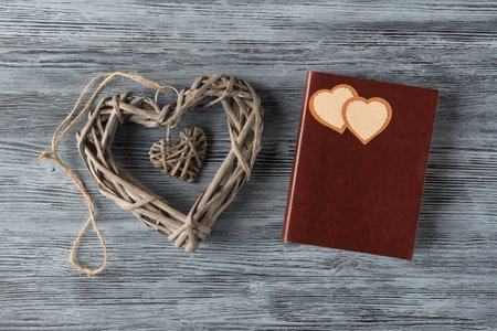 Valentineâs day background with craft hearts and notebook on aged wooden background. Valentines day greeting conceptの写真素材