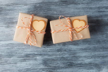 Two gift boxes and Valentines hearts made of zero waste materials on wooden background with copy space. Valentines day eco friendly packagingの写真素材
