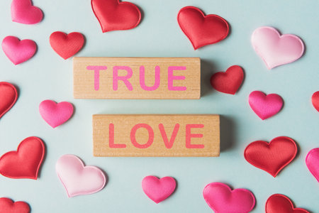 Valentines hearts and wooden blocks with words True Love. Valentineâs day greeting conceptの写真素材