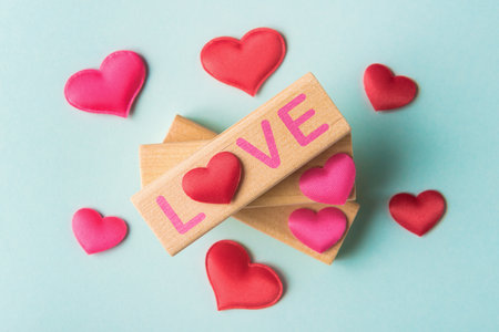 Valentineâs day concept with red hearts and blocks with word Love. St Valentineâs day greetingの写真素材