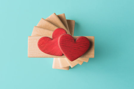 Two Valentines hearts on wooden blocks. Valentineâs day greetingの写真素材