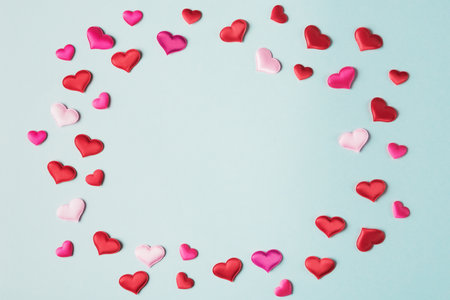 Valentineâs hearts on blue background with copy space. Valentines day greeting card templateの写真素材