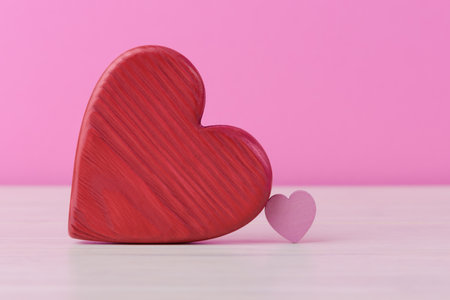 Big and small Valentines hearts over pink background with copy space. Valentineâs day conceptual greetingの写真素材