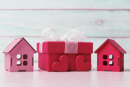 Viva magenta gift box, decorative houses and Valentineâs hearts against wooden background. Valentineâs day greeting conceptの写真素材