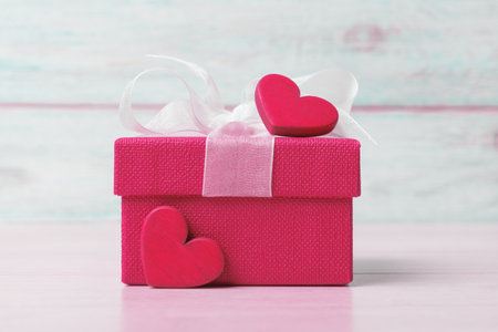 Viva magenta gift box and Valentineâs hearts against wooden background. Valentineâs day greeting conceptの写真素材