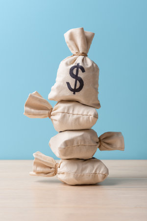 Money bags with Dollar sign over blue background with copy spaceの写真素材