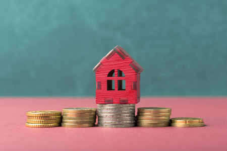 House model on Euro coins. Mortgage, real estate buying and house rental conceptの写真素材