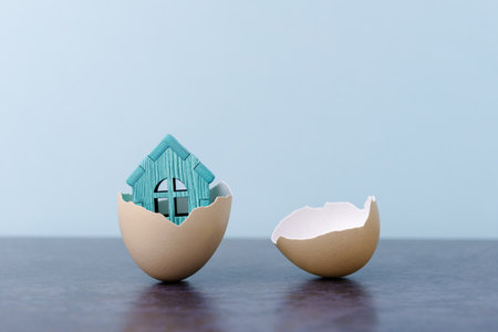 House in egg shell over light blue background with copy space. Conceptual Easter greeting cardの写真素材